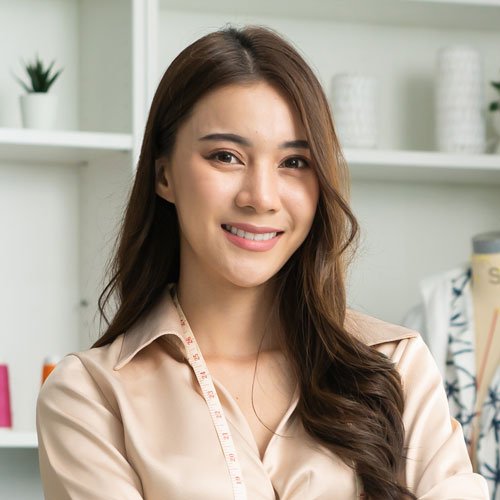 testi portrait of asian tailor woman working on clothes